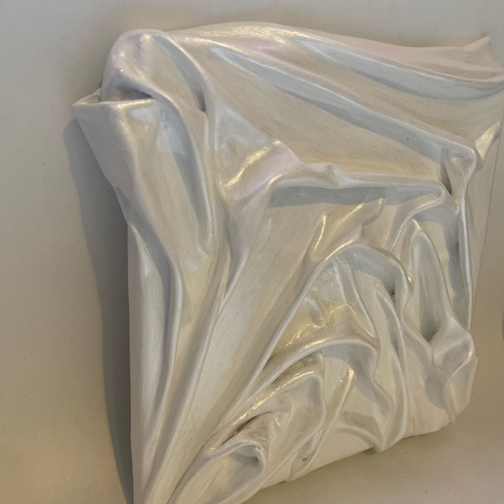 8x8 inch plaster wall sculpture with a white shimmer finish.